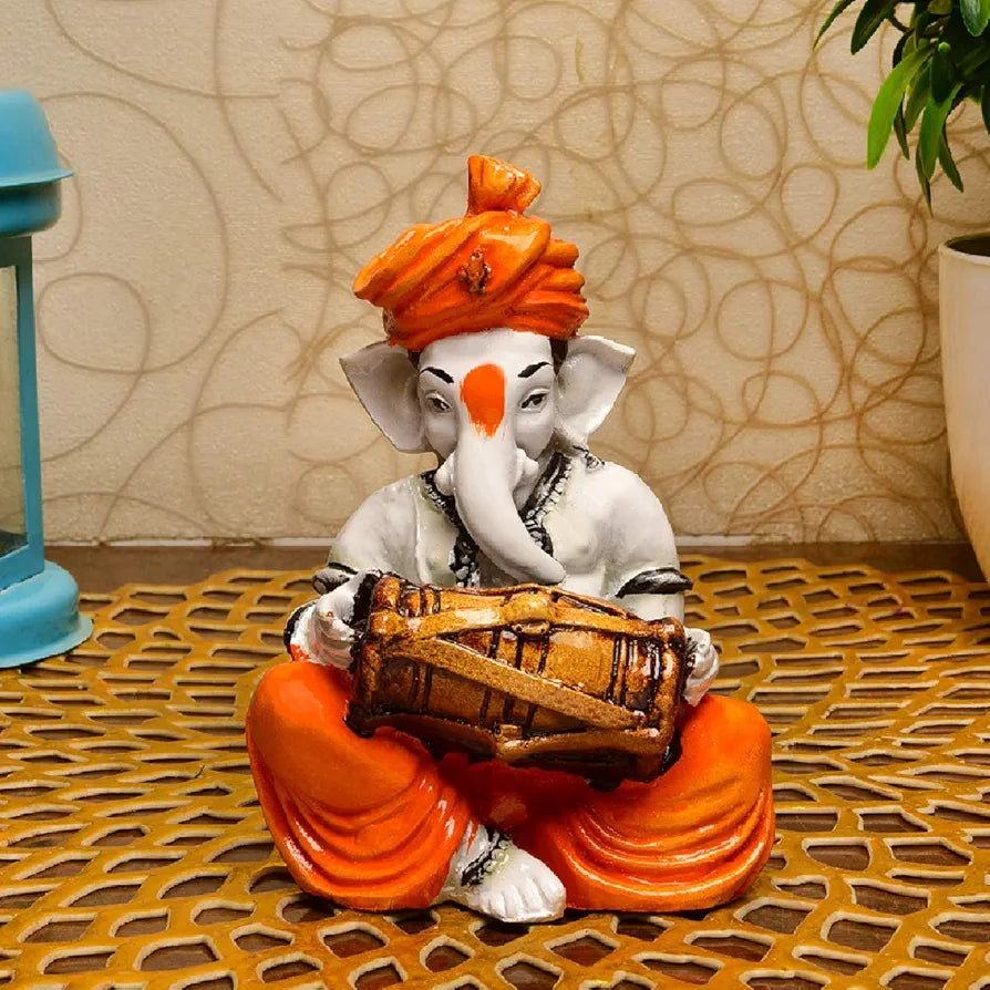 Karigaari India Karigaari Polyresine Orange & White Ganesha Playing Dholak