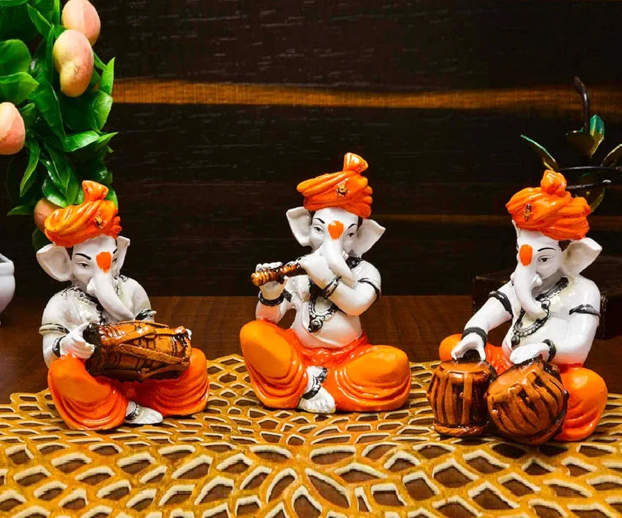 Karigaari India Polyresine Set of 3 Orange Dhoti & Turban Ganesha Playing Instruments Showpiece